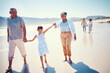 © Jesse Bettencourt/peopleimages.com - Relax, travel and holding hands with big family on beach for vacation, summer break and generations. Happiness, holiday and bonding with grandparents and children walking for love, rest and trip