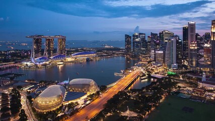 Wall Mural - Time lapse of Aerial Cloudy sky at Marina Bay Singapore city skyline from day to night