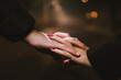 © Cavan Images - Closeup of white hands together in love in countryside