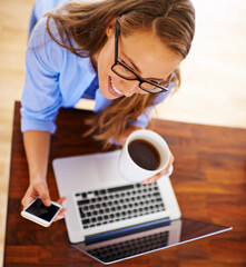 Sticker - Looking forward to a day of rest and relaxation. High angle shot of a young woman having coffee while sitting with her laptop and cellphone.