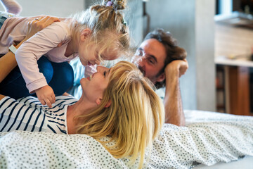 Wall Mural - Happy family having fun time at home. Parents child love concept.