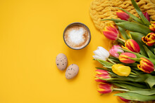 Beautiful Easter Frame Mockup With Tulips, Eggs And A Cup Of Coffee On A Bright Yellow Background. Top View. Copy Space. Flat Lay