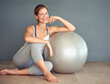 © C S W/peopleimages.com - Im ready to work my way health. Full length portrait of an attractive mature woman sitting next to an exercise ball.