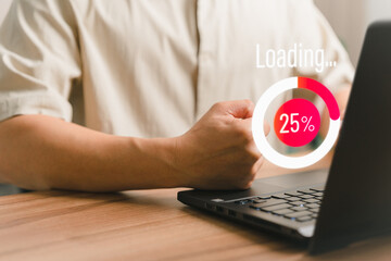 Adult man using a laptop computer for download software and waiting to loading digital business data form website, very slow internet form wifi. Concept of waiting for load of loading symbol.