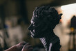 © primipil - Man sculptor creates sculpt bust clay human woman sculpture. Statue craft creation workshop.