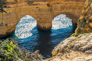 Wall Mural - Heart shape made by rocks and plants at Marinha Beach in Algarve, Portugal