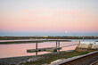© eunikas - Morning view of pier on Ria Formosa in Faro, with moon set shortly before sun rise, Algarve, Portugal