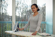 © AUFORT Jérome - mixed race woman ironing at home