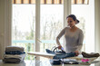 © AUFORT Jérome - mixed race woman ironing at home