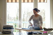 © AUFORT Jérome - mixed race woman ironing at home