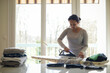 © AUFORT Jérome - mixed race woman ironing at home
