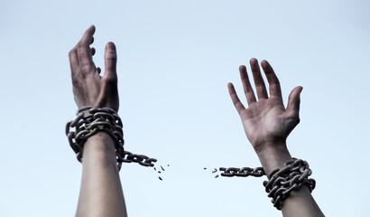 Praying man with shackled hands