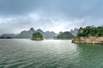 Na Hang lake in Tuyen Quang province, Viet Nam. This natural lake has a green watercolor. It is located between the majestic cliffs. Every year this place attracts many tourists to visit