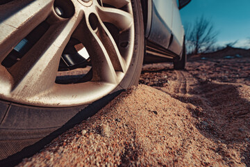 Canvas Print - Car wheel on sand close-up view