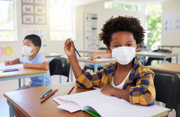 Sticker - Child or student in class during covid, wearing a mask for hygiene and protection from coronavirus flu. Portrait kindergarten, preschool or elementary school boy sitting in a classroom ready to learn