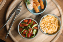 Overhead View Of A Brunch Plate With Scrambled Eggs, Sausages, Cucumber And Tomato