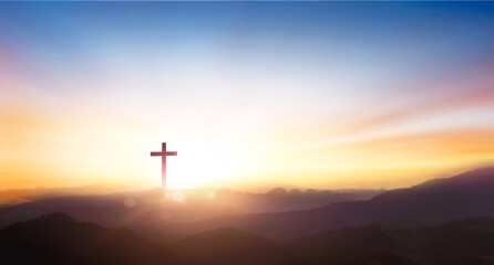 silhouette of crucifix cross on mountain at sunset sky background.