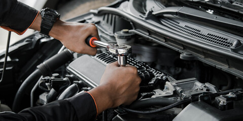 Mechanic fixing a car at home. Repair and service.