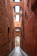 Narrow Old Street With Several Upstairs Passages, In Siena, Tuscany, Italy