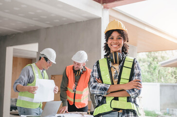 Wall Mural - Leadership Concept by Female Engineers : Portrait of a happy female engineer in front of a group of male construction workers : Effective teamwork