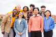 © Jose Calsina - Portrait of big group of teenage multiracial young friends smiling and looking at camera. Front view of a lot of happy school students laughing and having fun together standing outdoors. Friendship
