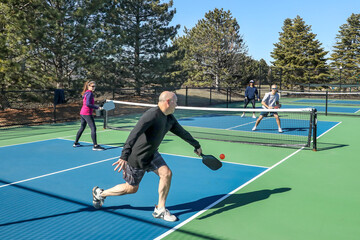 Men and Women in a Doubles Game of Pickleball