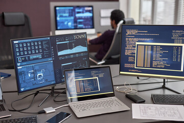 Various computer screen with code lines and data on desk in IT development or data science office
