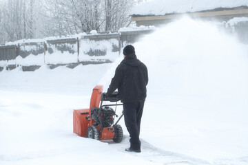 Wall Mural - A portable snow blower powered by gasoline. Snow removal in winter.