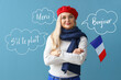 Beautiful woman with flag of France on light blue background. International French Language Day
