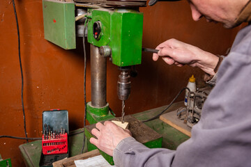 Wall Mural - A carpenter works in a workshop with a saw, planer and various tools