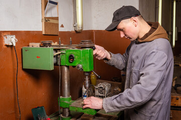 Wall Mural - A carpenter works in a workshop with a saw, planer and various tools