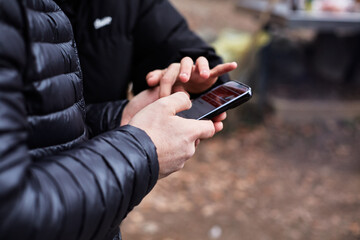 Male hands using mobile phone