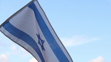 Flag Of Israel Video. Waving Israeli Flag Slow Motion Video. Israel Flag On The Blue Sky Background With Clouds 