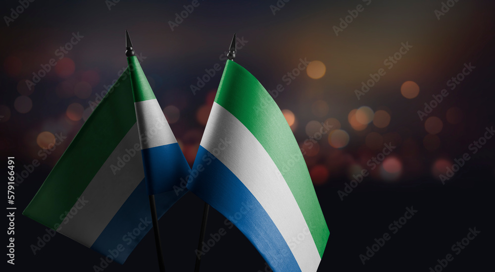 Small flags of the Sierra Leone on an abstract blurry background の ...