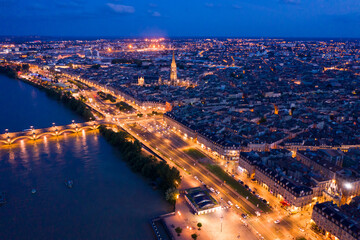 Wall Mural - Aerial view of Bordeaux cityscape on banks of Garonne river and Pont de pierre at night