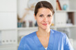 © JackF - Smiling adult doctor assistant standing in medical office