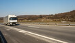 © Bojan - Truck with container on highway, cargo transportation concept.