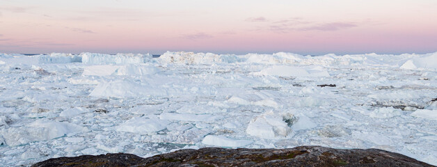 Wall Mural - global warming and climate change. iceberg from melting glacier in ilulissat, greenland. midnight su