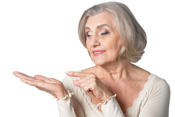 Poster - Portrait of smiling senior woman pointing at something