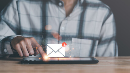 Email marketing and newsletter concept,Digital communication with email messages,Sending and receiving messages online with the email icon ,man reading electronic mail from tablet ,online notification