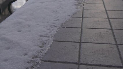 Wall Mural - Man found lost phone on a pavement. Man's hand lifting broken smartphone from ground in slow motion.