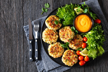 Sticker - crab cakes with sauce, lettuce, tomatoes, lemon