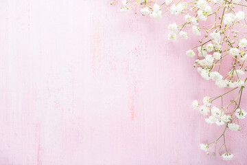 Sticker - Tiny  white flowers of Gypsophila on a light pink shabby wooden background. Top view with copy space. Flat lay. Selective focus