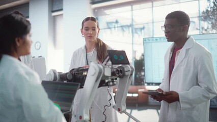 Poster - Diverse Team of Industrial Robotics Specialists Gathered Around a Table With a Mobile Robot. Engineers In Lab Coats Discussing an Automated AI Robotic Dog, Using Laptop and Tablet, Brainstorming