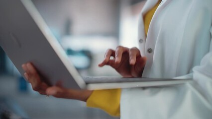 Aufkleber - Close Up on the Hands of a Black Female in a Lab Coat Using Laptop Computer, Scrolling, and Clicking. African American Woman Working as Professional Engineer in Startup, Analysing Results and Data