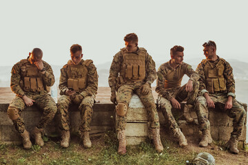 Soldiers squad relaxing after battle having a break on training