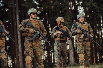 Wall Mural - Soldier fighters standing together with guns. Group portrait of US army elite members, private military company servicemen, anti terrorist squad