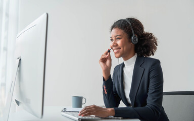 close up call center operator in wireless headset talking with customer, woman in headphones with microphone consulting client on phone in customer support service, looking at computer screen