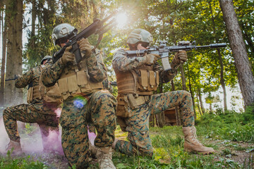 Wall Mural - Soldier fighters standing together with guns. Group portrait of US army elite members, private military company servicemen, anti terrorist squad