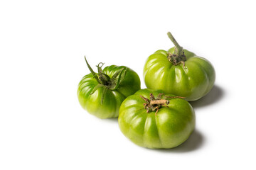 Green raw tomatoes on the white background.